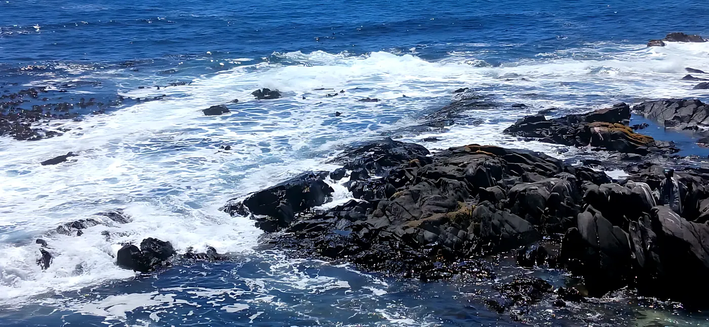 Atlantic waves over dark rocks